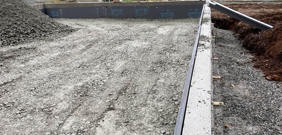 Foundation excavation with insulated concrete form walls and gravel base