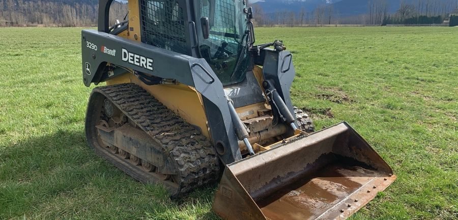 Compact track loader with grading bucket on a North Idaho jobsite
